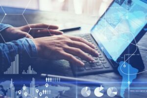 Concept of virtual diagram,graph interfaces,digital display,connections,statistics icons.Man using contemporary electronic tablet with dock keyboard.Blurred background. Horizontal.